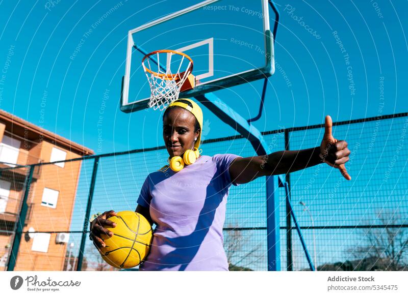 Black female basketball player showing shaka sign on outdoor sports ground woman gesture confident cool athlete sportswoman young african american black ethnic