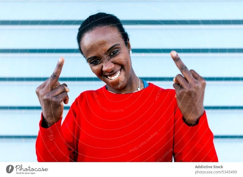 Self assured woman with fuck you gesture model middle finger naughty self assured portrait female black african american fuck off show expressive provocative