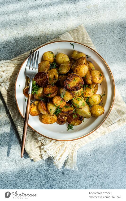 Spring potato in dish on grey background bowl cutlery diet dieting dill dinner plate drill eat food fresh fried green green onion healthy herb keto ketogenic