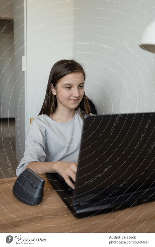 Young pensive teen girl with laptop in study room student work contemplate remote home using device table gadget female online smile casual schoolgirl