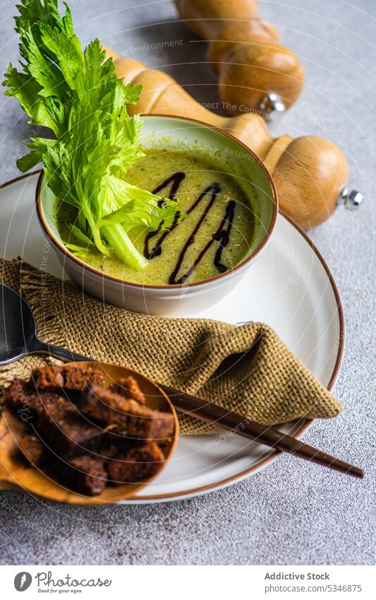 Healthy celery cream soup in bowl with celery sticks on table bread colorful concrete creamy detox diet dinner dinnerware eat food fresh green healthy herb keto