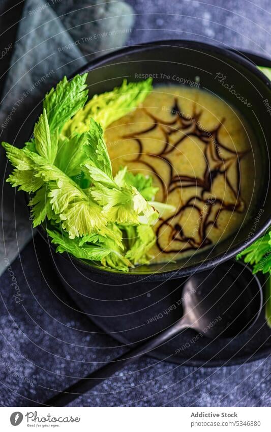High angle of healthy celery cream soup in bowl against blurred background creamy detox diet dinner eat food fresh green herb keto lunch meal organic plate raw