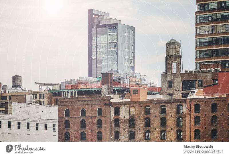 Retro toned picture of New York City industrial cityscape with water towers, USA. NYC building Manhattan window architecture old symbol view day urban retro