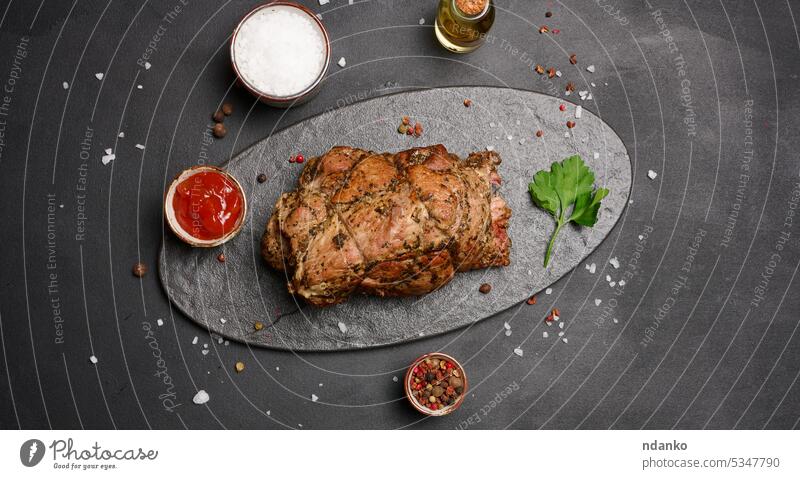 Baked pork collar with spices on a wooden board, delicious and juicy meat roasted seasoning flavors succulent tender marinated savory appetizing oil sauce