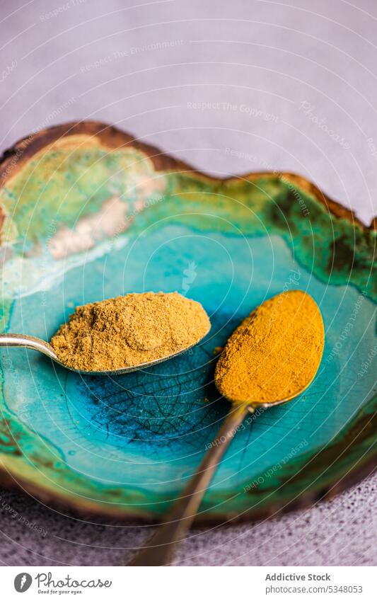 Spoon with powdery spices background turmeric ginger concrete cook cooking eat eating food ingredient kitchen meal plate siam tulip spicy spoon stoneware table
