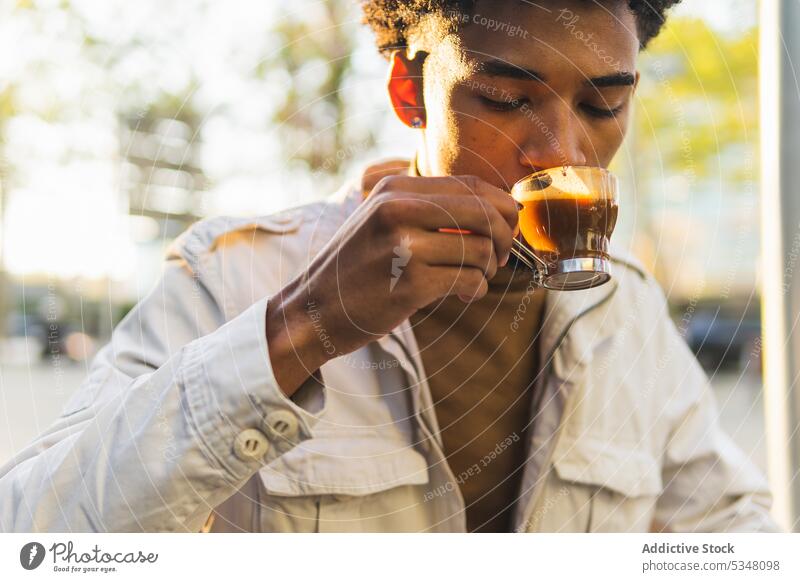 Pensive black man drinking hot espresso on street coffee pensive thoughtful cup hot drink afro beverage african american young casual takeaway serious male city