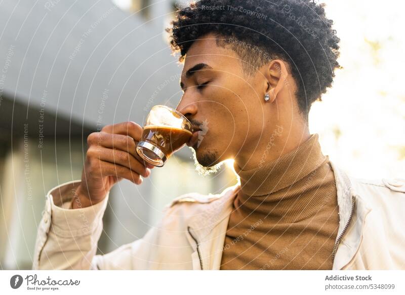 Pensive black man drinking hot espresso on street coffee pensive thoughtful cup hot drink afro beverage african american young casual takeaway to go male