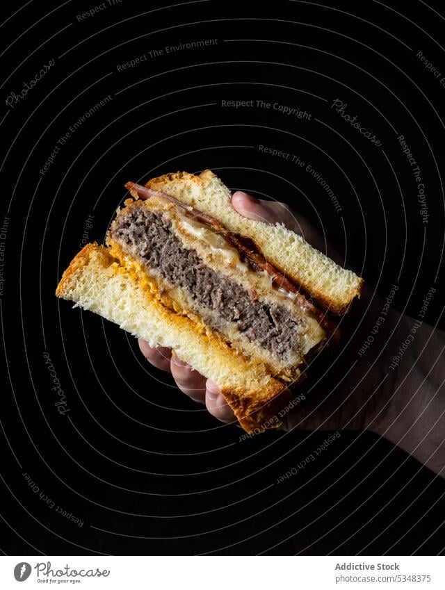Crop person with delicious sandwich anonymous food burger appetizing bacon tasty meal fast food patty snack lunch cheese yummy dish gourmet cuisine piece