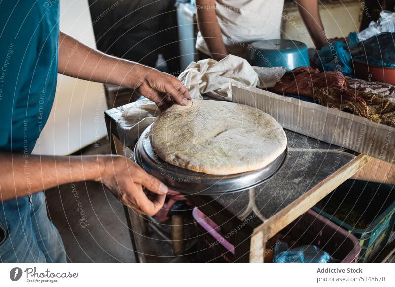 Cropped man making traditional bread prepare bake local cook dough baker cuisine spread raw recipe culinary bakery marrakesh morocco food process kitchen