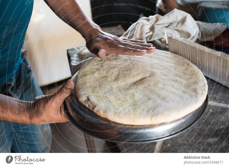 Crop man making traditional bread prepare bake local cook dough baker cuisine spread raw recipe culinary bakery marrakesh morocco food process kitchen produce