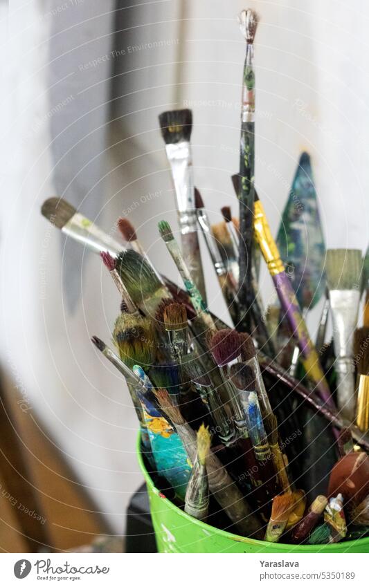 photo of a paint brush in a bucket artist many tool colours artistic paintbrush background design acrylic creativity education painter painting creative