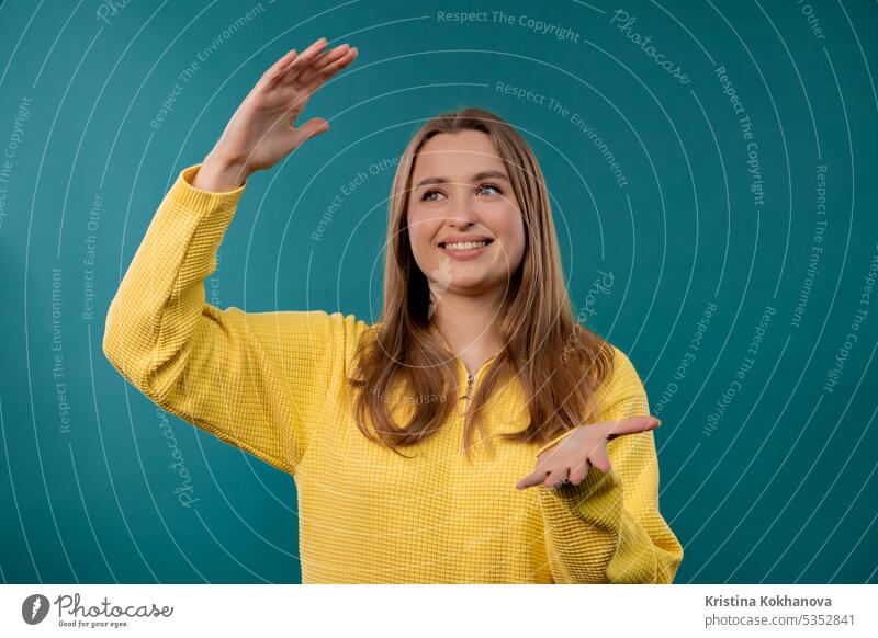 Young woman showing big invisible abstract subject, object sizes. Large, giant arm background between bigger bit close concept design empty female finger