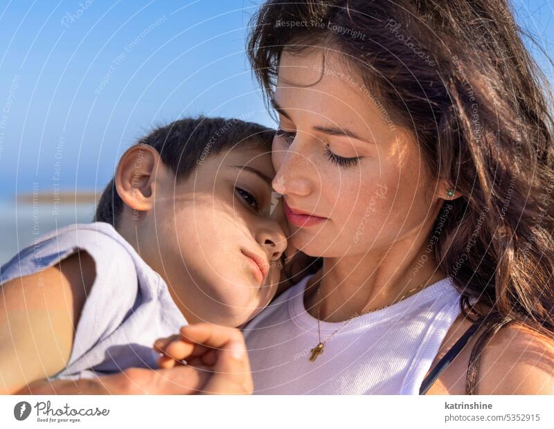 Mother and son spending time together outdoor at sunset. Lovely Family relax love family woman boy sunny day Toddler kid boy Mom spring summer blue sky child
