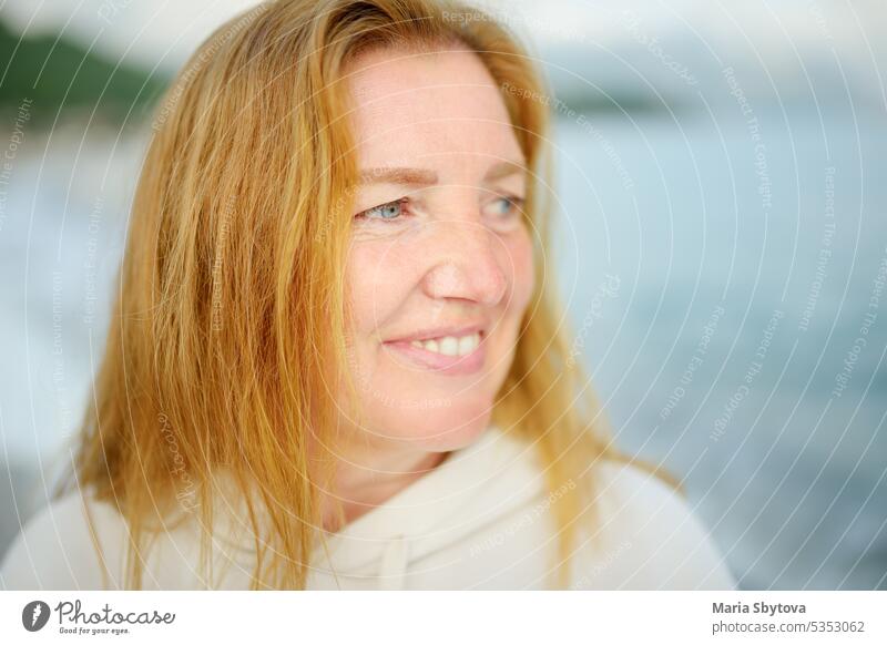 Portrait of a blue eyes and redheaded caucasian senior woman. mother adult people portrait real sea mothers day affection love white happy women retired