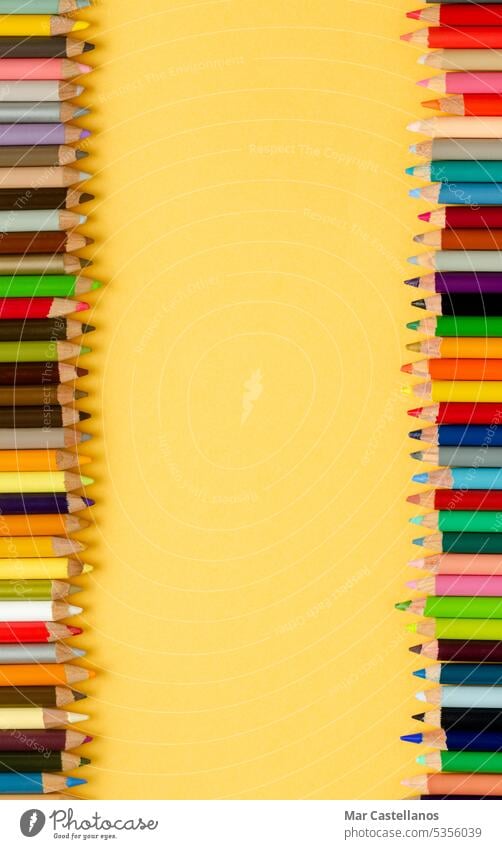 Back to class. Coloured pencils on yellow background. Copy space. Vertical photo. Back to school envelope Top view copy cream pastel education primary secondary