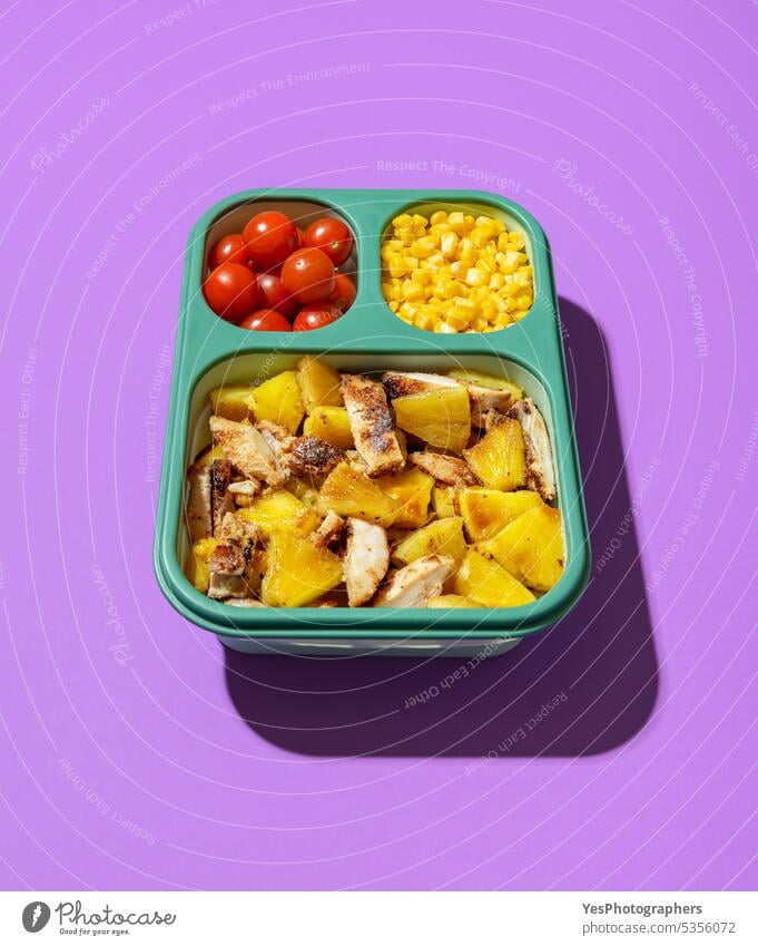 Lunch box with summer salad on a purple background. Prep meal lunch box. above bright cherry chicken color container copy space corn cuisine delicious diet dish