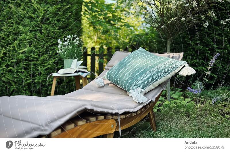 Favorite place | lounger with pillow and table with book in garden Garden Couch Cushion Book Table Eyeglasses Hedge Garden Bed (Horticulture) flowers plants
