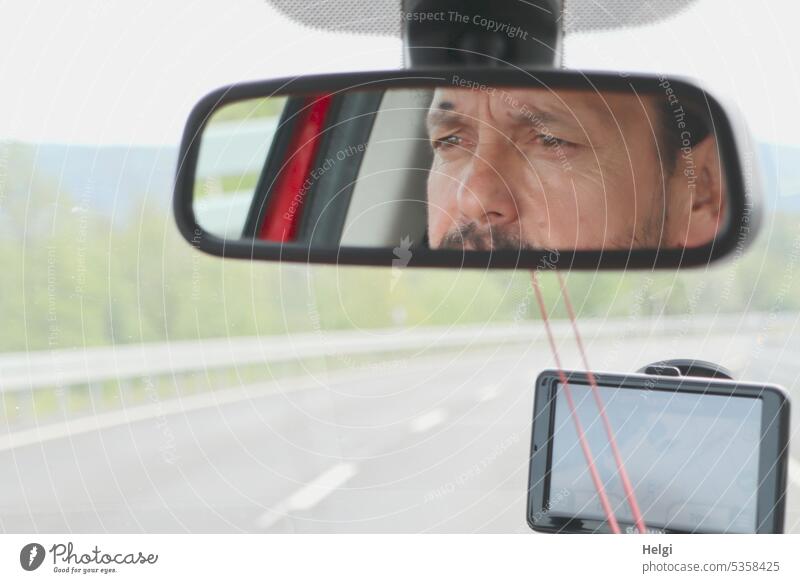 Mainfux-UT | concentrated Fux in mirror while driving a car Human being Man Mirror car mirrors Mirror image Face eyes Nose Ear Facial hair Vehicle navi