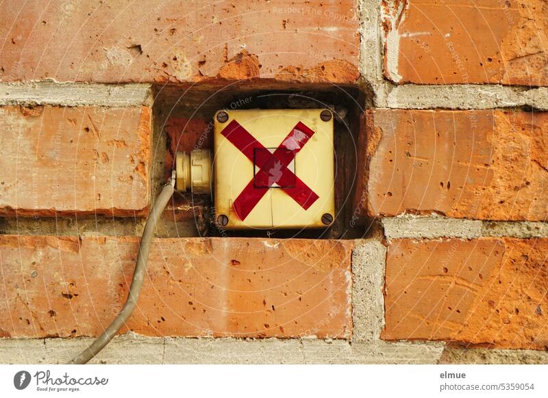 switch with cable covered with red tape, embedded in red brick wall Switch Adhesive tape pasted up unusable Crucifix security measure Broken Cable Electricity