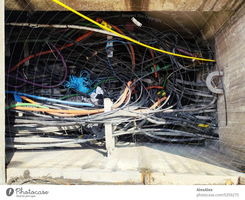 open cable tunnel under sidewalk with many black and colored cables - chaos Cable Black variegated stream Energy Tunnel Cable tunnel Electricity Provision havoc