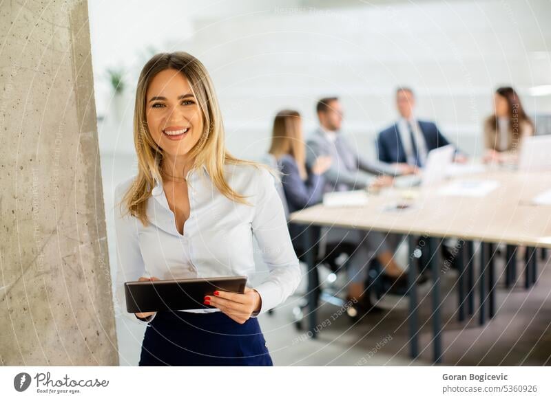 Young business woman with digital tablet in the office hallway project employee businesswoman businessman team people job career occupation enterprise