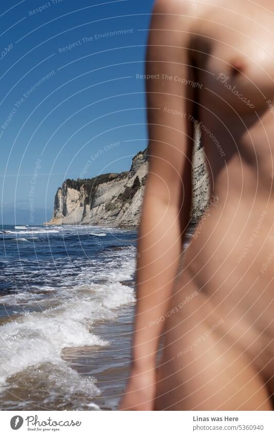 What a tremendous view with a naked girl out of focus. Of course, you can see the beautiful coastline of Corfu, Greece. Though a gorgeous topless girl who is spreading nipples out message is still the main focus. Even if she’s blurred out a bit.