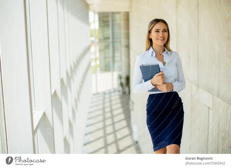 Young business woman walking on stairs in the office hallway adult beautiful building businesspeople businesswomen caucasian climbing coworker daytime employee