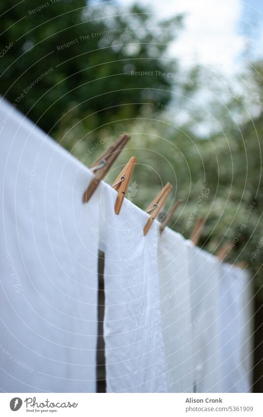 white laundry on a washing line white washing clothes line good drying day out to dry white clothes domestic jobs domestic chores outside washing day