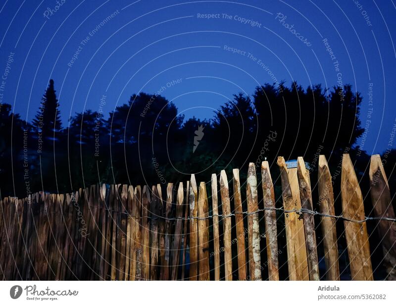 Wooden fence at night with trees in background Fence Garden Real estate Border Night Dark Blue Blue sky Black Garden fence Exterior shot