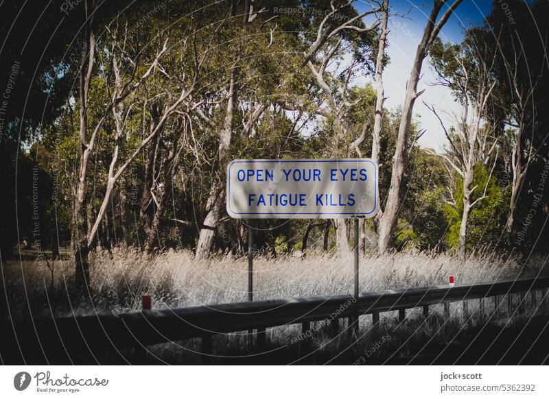 OPEN YOUR EYES FATIGUE KILLS Warning sign Traffic infrastructure Road sign Safety vegetation Australia trees Crash barrier Signs and labeling English Signage