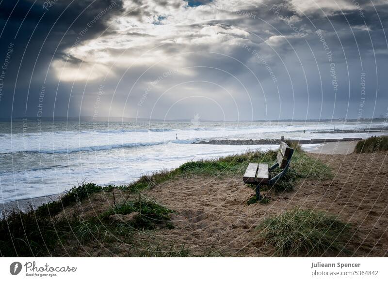 Bench overlooking the ocean during stormy weather beach atmospheric Beach Landscape Ocean Clouds Exterior shot Sky Coast Colour photo Deserted Waves Nature