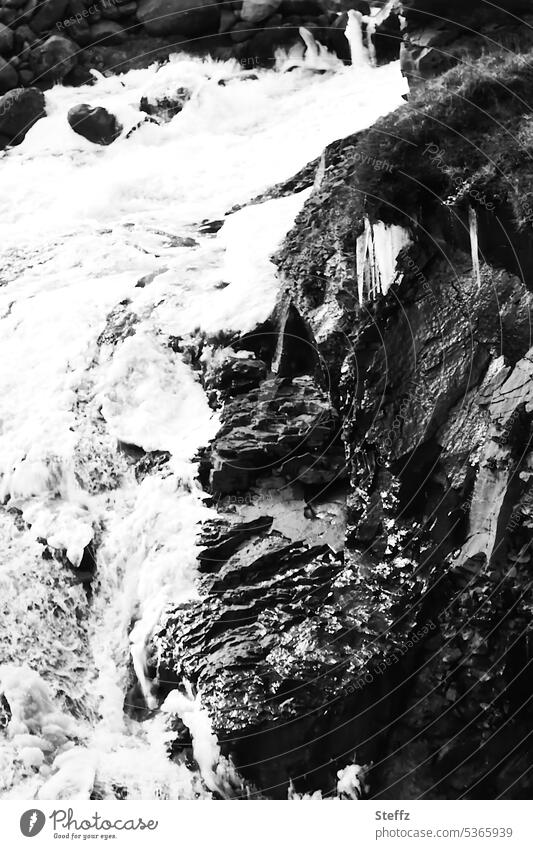 Waterfall cutout with rocks and icy water on Iceland East Iceland waterfall neckline icily Cold Water cascade Frost chill icy cold water elemental iceland trip