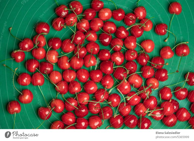 Red cherries on a green background billboard advertising Billboard naturally Eating Vegan diet cherry red Vitamin-rich Food photograph Nutrition Healthy Eating