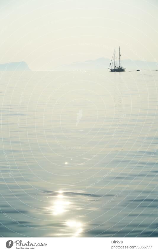 Sailing yacht in the morning backlight on the Aegean Sea with light reflections on the water surface Ocean sailing yacht Sailboat Vacation & Travel Water Summer