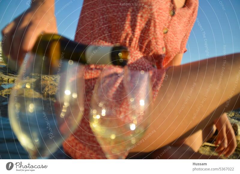 photo of hand of lady pouring wine beside the beach wineglass celebrate Lifestyle sea Champagne glass Prosecco Drinking Sparkling wine Summer Glass Beverage