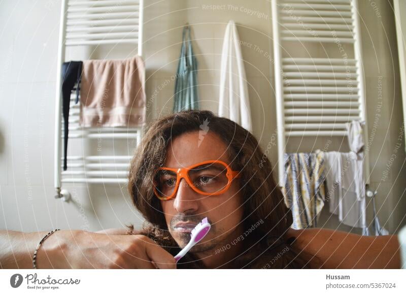 photo of person in the bathroom brushing his teeth and day dreaming wearing funky glasses Teeth Man Bathroom beautiful people morning routine good looking