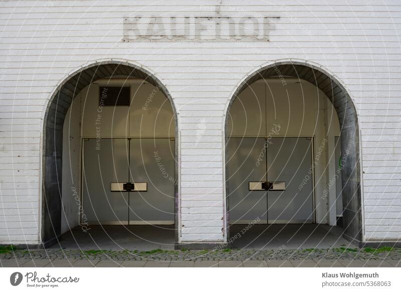 Gray in gray/ Image with symbolic character. Closed doors of a former Kaufhoff branch closed door Manmade structures Mall Shopping center Building Exterior shot