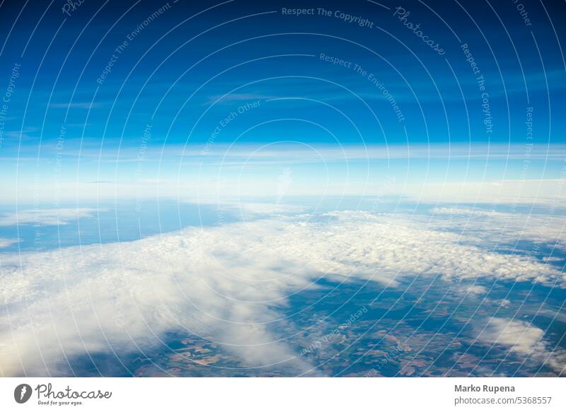 View over clouds from an airplane cloudscape sky above atmosphere travel blue bright clear cloudy day flight fly freedom heaven high horizon landscape