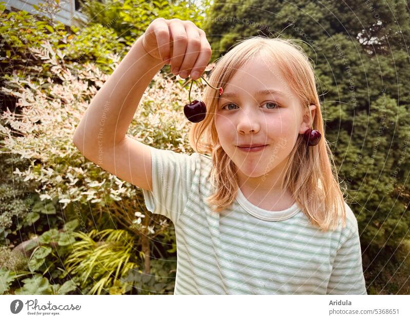 Child now holds only one cherry in hand cherries Summer Harvest Fruit nibble Infancy Joy Red Mature Nature Garden Food Cherry cute Eating Smiling Brash