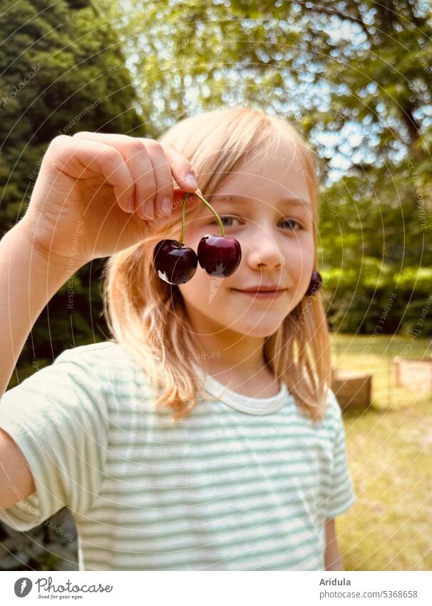 Child holding two cherries in hand Summer Harvest Fruit nibble Infancy Joy Red Mature Nature Garden Food Cherry cute Smiling Looking into the camera Hand