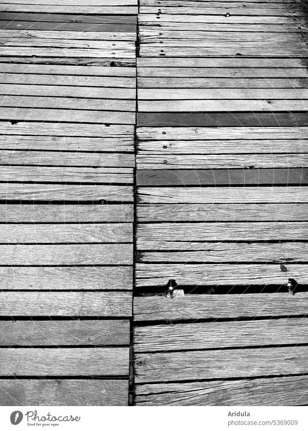 gray in gray | wooden bar b/w Footbridge Wood wooden slats Water Shades of grey Structures and shapes Lanes & trails Lake Bridge Wooden board wooden walkway