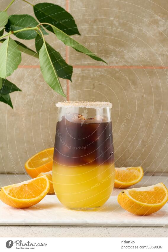Cold coffee with orange juice in a transparent glass and orange slices brown sweet cool espresso cold drink fresh beverage cocktail morning caffeine fruit syrup