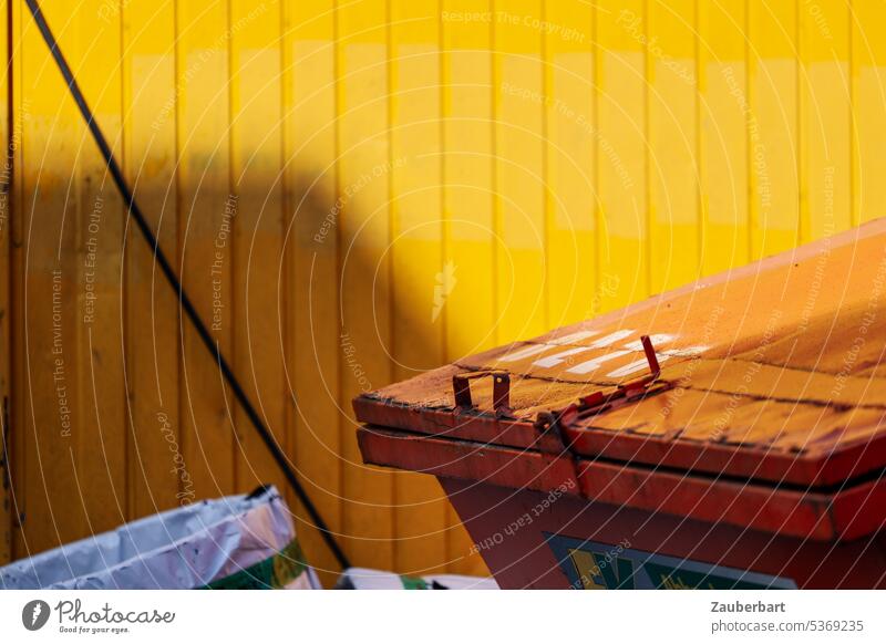 Container in orange in front of yellow wall Wall (building) Yellow Orange Facade Industrial area clash Colour colored variegated sunny Shadow waste Elimination