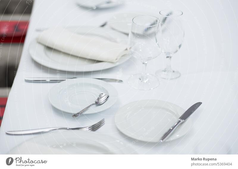 White empty plates and glasses served on a table for a celebration tablecloth dishes restaurant dishware tableware white clean kitchenware eat crystal objects