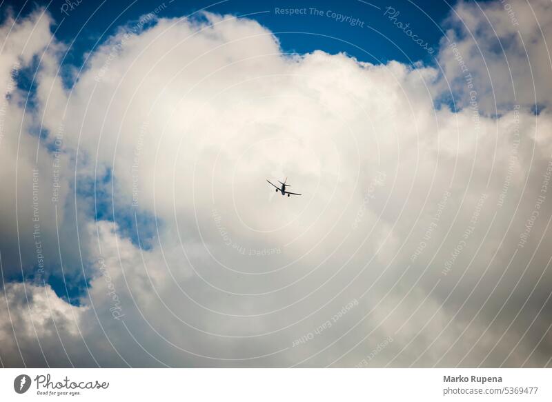 Airplane flying with clouds in background flight aircraft airliner airplane aviation blue business cloudscape cumulus departure high jet journey sky take-off