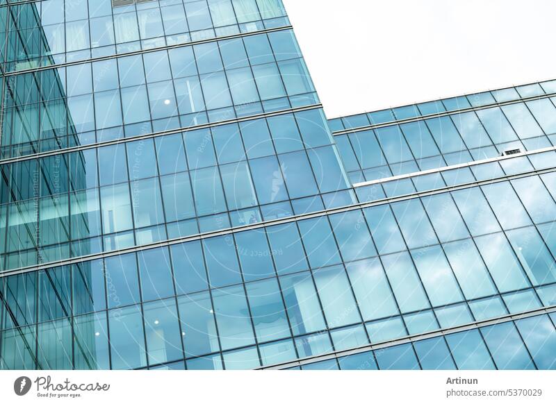 Modern sustainable glass office building. Exterior view of corporate headquarters glass building architecture. Energy-efficient building. Financial business center tower. Glass windows of company.