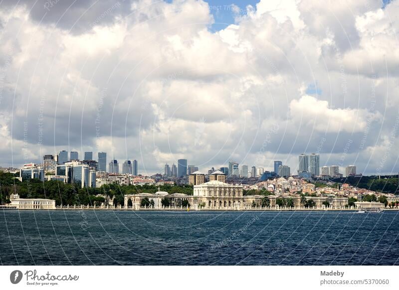 View from the ferry to Üsküdar to Dolmabahce Palace in Besiktas district in summer with clouds and sunshine in Istanbul on the Bosporus in Turkey far vision