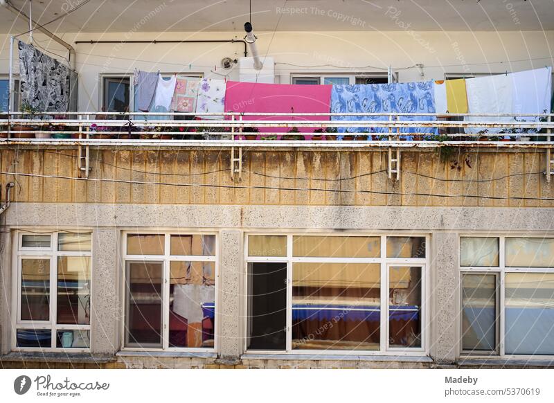 Clothesline with colorful clothes on the balcony of an old residential house in summer sunshine at the bazaar in Adapazari, Sakarya province, Turkey adapazari