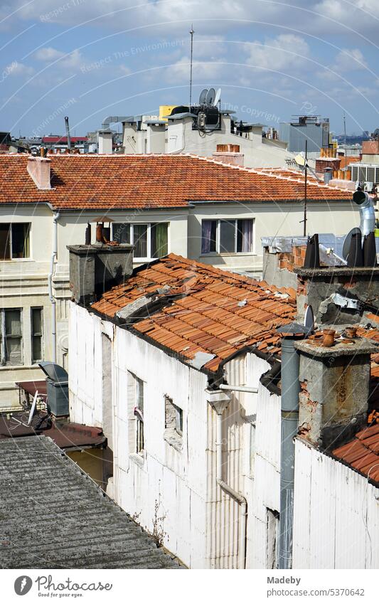 View from a roof terrace on flat roofs with red tiles in summer sunshine at Istiklal Caddesi in Taksim in the Beyoglu district of Istanbul on the Bosporus in Turkey