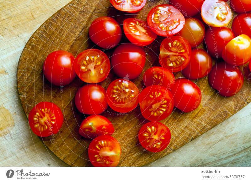 Small tomatoes halved Nutrition Eating Fresh Fruit Vegetable salubriously Household Cook boil Kitchen Meal food fruit chopping board Chopping board cut pieces
